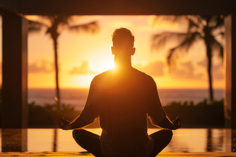 Image of a person meditating with light over their head