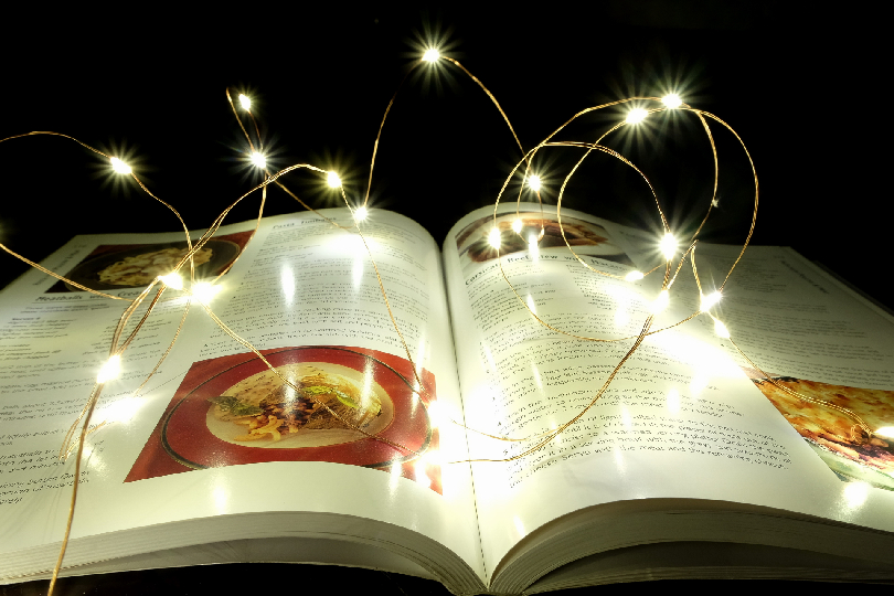 Image of an open book glowing with light (Akashic Records Healing Andheri for Deep Subconscious Exploration)