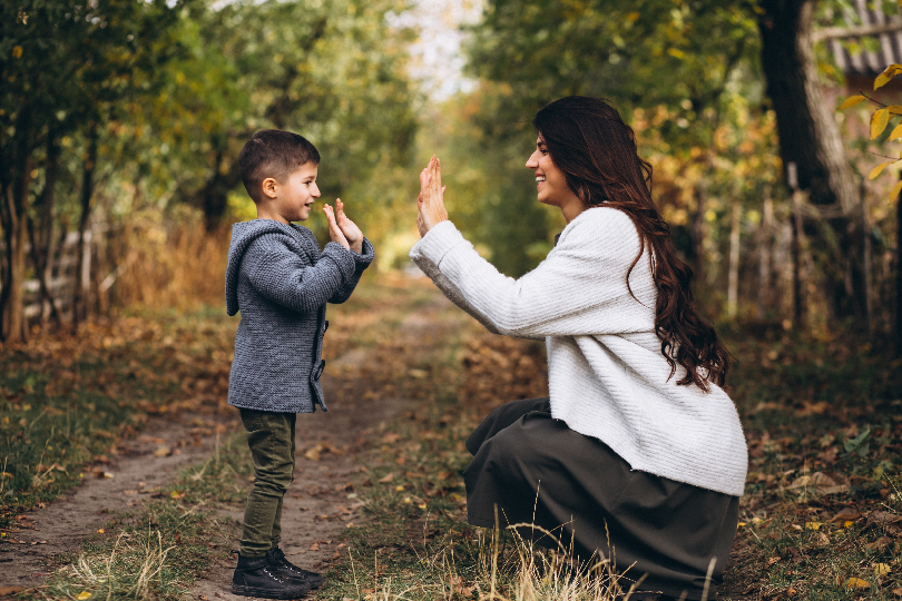 Image of a confident adult embracing a small child (Childhood Memory Regression for Emotional Freedom)