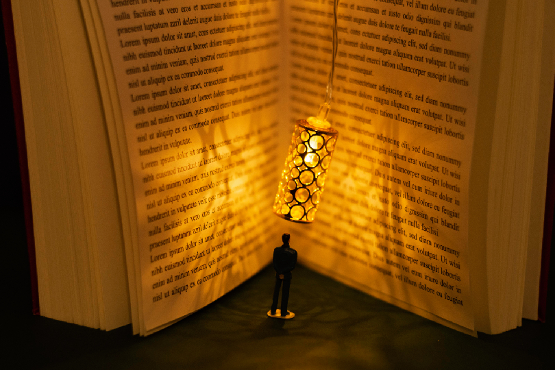 Image of a person holding a golden key in front of a glowing library (Akashic Records Reading and Wealth
